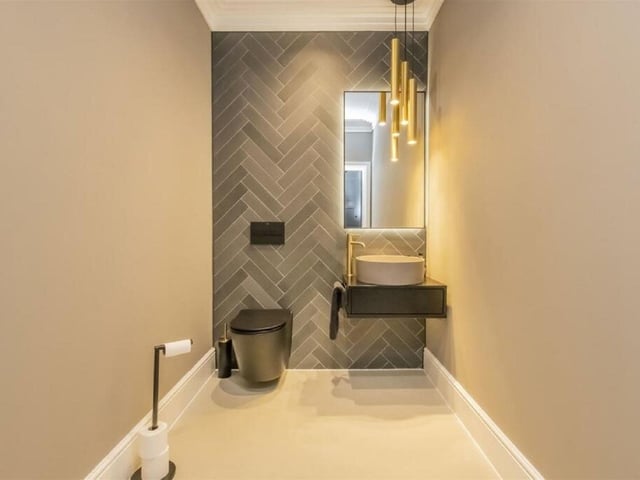 A downstairs luxury loo boasts fabulous lighting. Nearly all of the property's bedrooms have en-suites