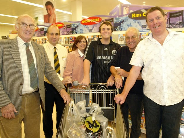 Northampton Lions trolley dash at Morrisons supermarket, Kettering Road. Pictured: Anthony Brown with staff from Morrisons and members of Northampton Lions after his trolley dash.