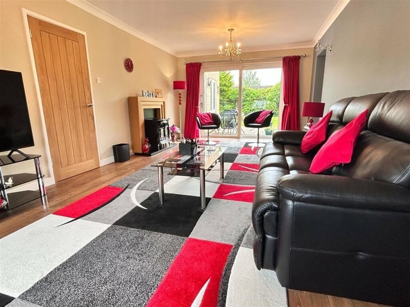 A plush sitting room with French doors leading out to the patio
