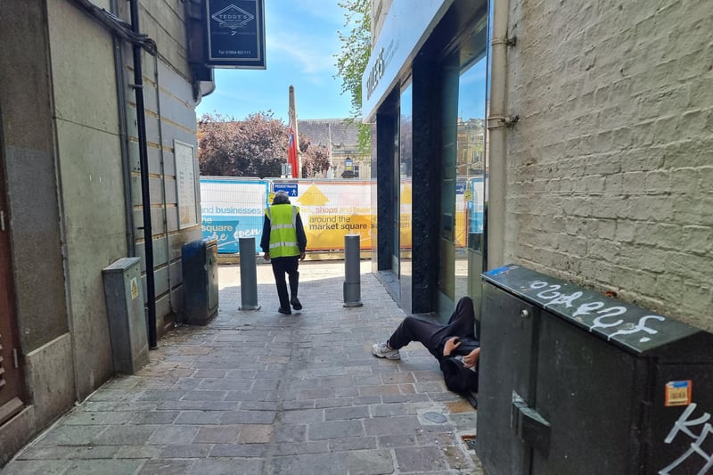 Someone having a lie down in a refurbished alleyway next to the Market Square