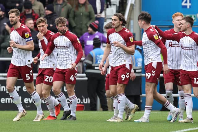 The Cobblers players celebrate Louis Appere's first-half goal