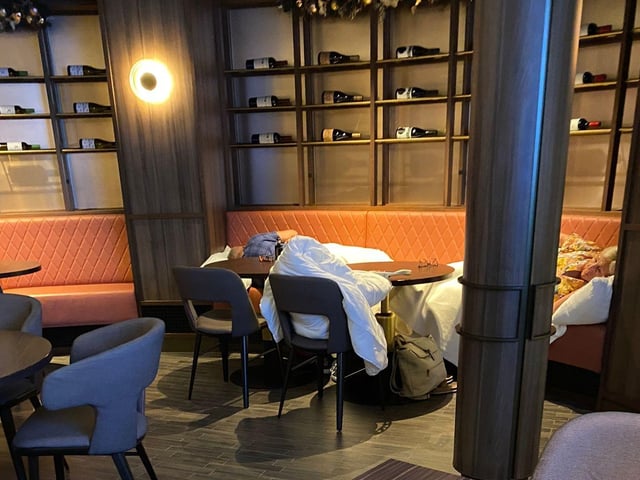 Passengers pictured sleeping in P&O Cruises' Glass House Restaurant after they were left stranded without access to other facilities.