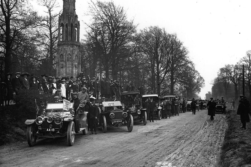 Motor cars and spectators at Queen Eleanor's Cross, Northampton, on the 10th anniversary of the 1,000 miles trial on 22nd April 1910.