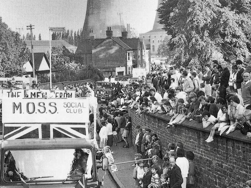 The town carnival passing through. Note the Nun Mills Power Station in the background, located on the south bank of the River Nene, which is where the University's Waterside campus now sits.