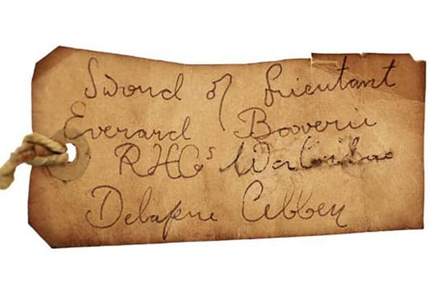 The tag on the sword, showing it belongs to Everard Bouverie.