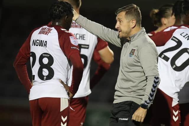 Cobblers manager Jon Brady issues instructions to teenage attacker Miguel Ngwa during Tuesday's loss to Cambridge United (Picture: Pete Norton)