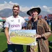 Andy Brown with Jimmy Anderson with the artists painting of Jimmy taking his 700th Wicket