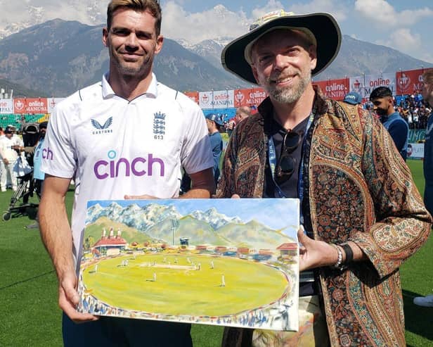 Andy Brown with Jimmy Anderson with the artists painting of Jimmy taking his 700th Wicket