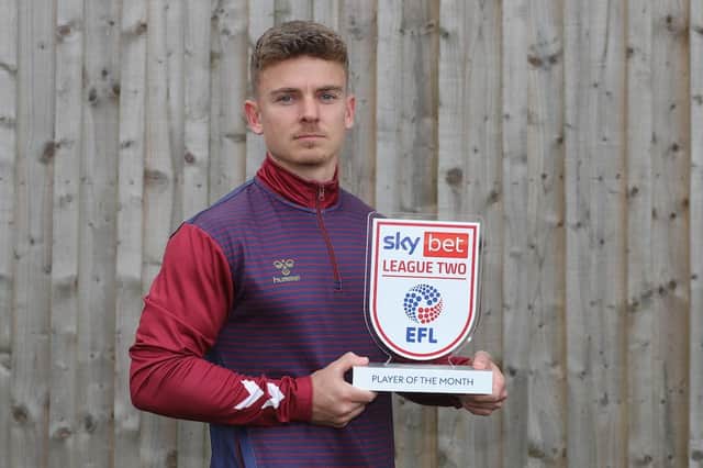 Sam Hoskins shows off his Sky Bet League Two player of the month award for August