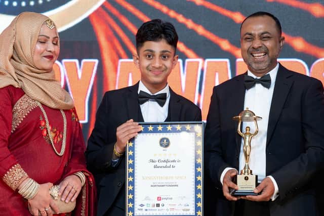 Mamun Ali (right) and his family picking up the award