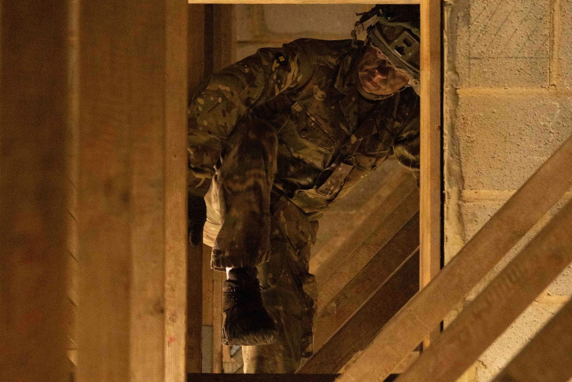 Private Warren from 2nd Battalion The Royal Anglian Regiment crawls through roof rafters during his run through the Confidence Course in Copehill Down. The course was part of the regiment's build up training ahead of their deployment onto Exercise Wessex Storm.