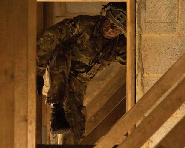 Private Warren from 2nd Battalion The Royal Anglian Regiment crawls through roof rafters during his run through the Confidence Course in Copehill Down. The course was part of the regiment's build up training ahead of their deployment onto Exercise Wessex Storm.