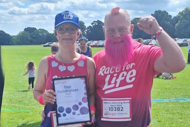 Leanne with the certificate for top fundraising team at Race For Life in Northampton