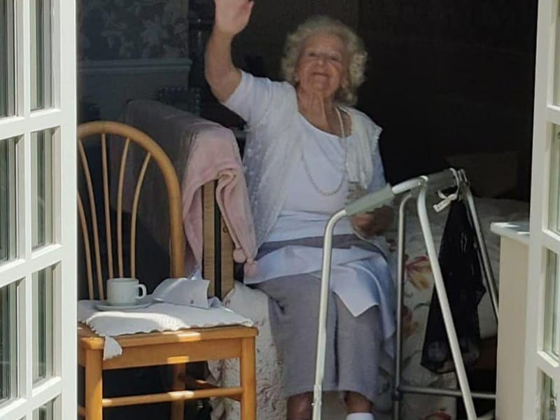 Resident May watched the performance for her room in the home