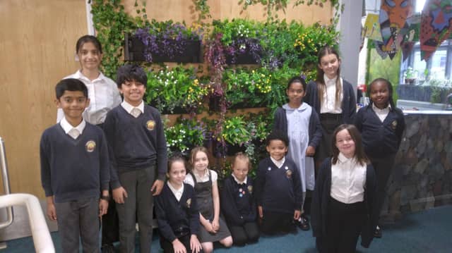Members of the eco-committee celebrating their Green Flag award in the school garden.