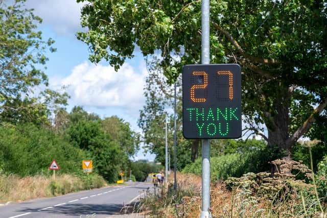 The signs flash at drivers to slow them down.