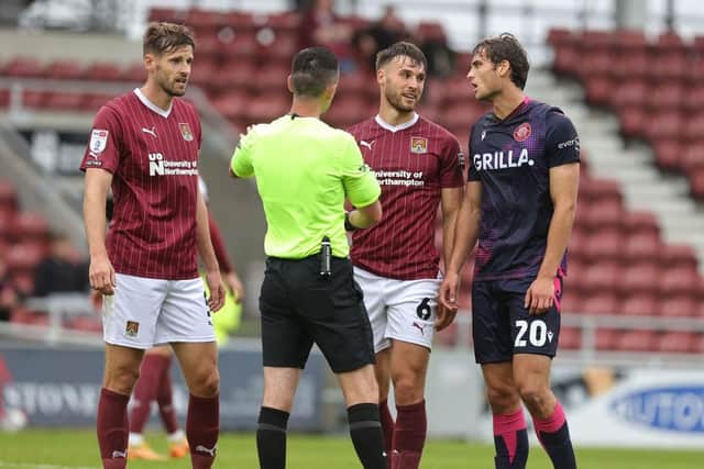 Referee Lewis Smith speaks to Jon Guthrie, Sam Sherring and Stevenage's Aaron Pressley during Saturday's Sky Bet League One match. (Photo by Pete Norton/Getty Images)