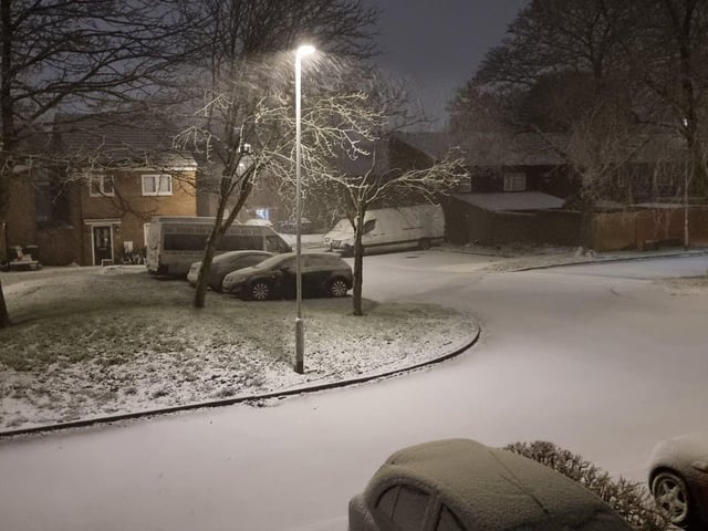 Thick snow settling on cars.
