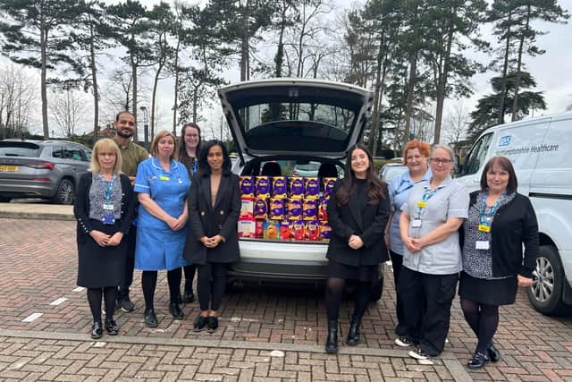 Karen Bhangal and Katie Newman present the Easter eggs to hospice staff