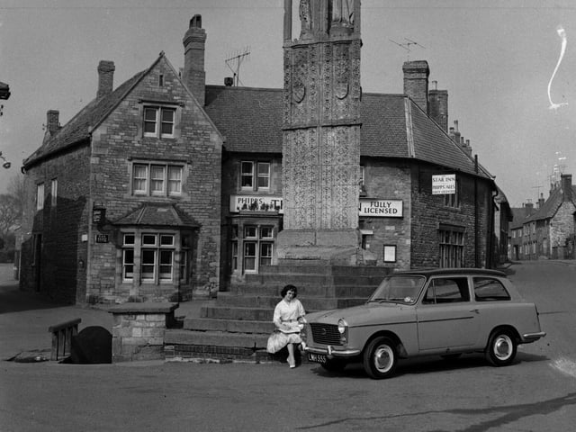 Advertisement feature picture for S & W Motors, Northampton, taken at the Queen Eleanor Cross, Geddington, March 25, 1960