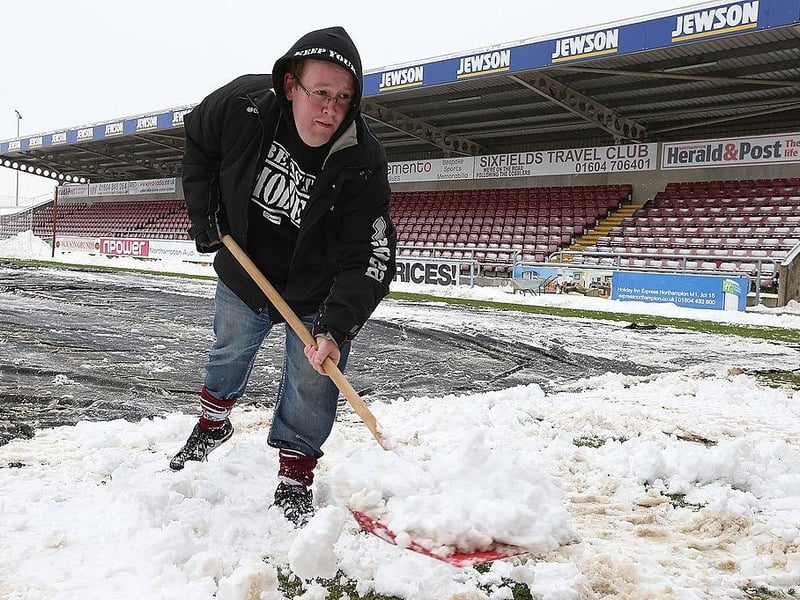 Fans clear snow from the pitch in an attempt to allow the npower League Two match between Northampton Town and Burton Albion to go ahead at Sixfields Stadium on January 19, 2013.