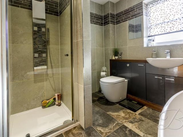 Bathtime can only be fun in this pleasant family bathroom. Fully tiled, it comes complete with a standalone bath, walk-in shower, low-flush WC, hand wash basin and storage.
