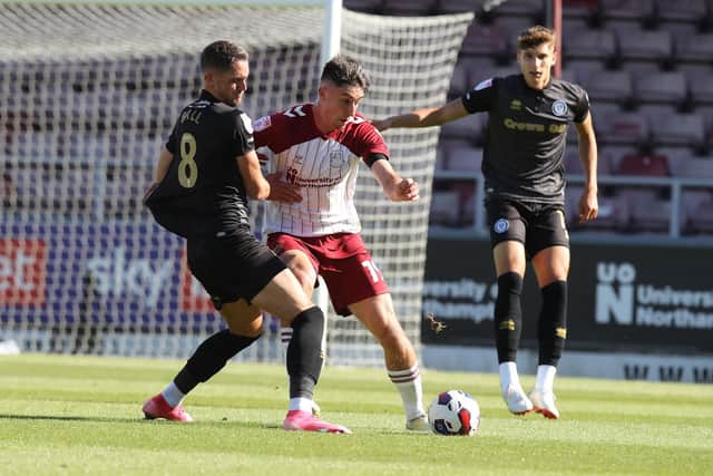 Kieron Bowie battles for possession for the Cobblers against Rochdale (Picture: Pete Norton)