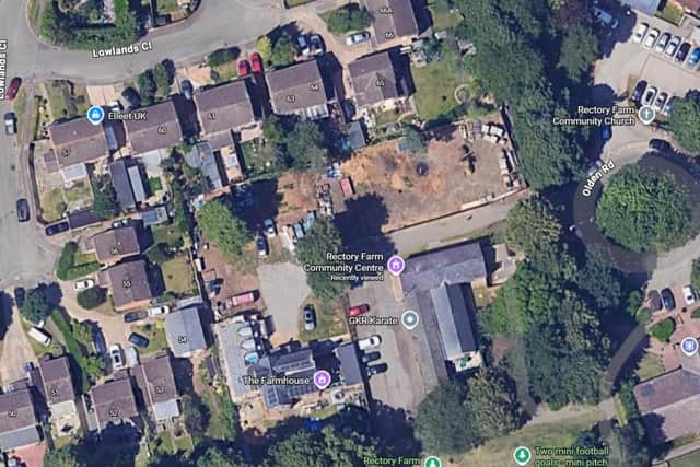 Plans were lodged to build three homes in unused space behind the Rectory Farm Community Centre .