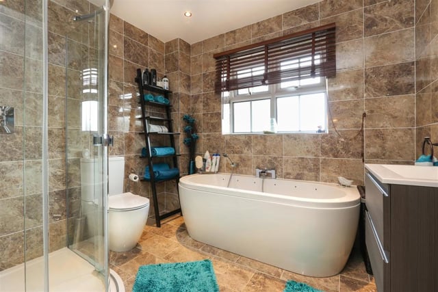 The stylish bathroom suite includes a bath and separate shower.