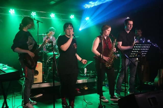 Group of student musicians performing on stage.