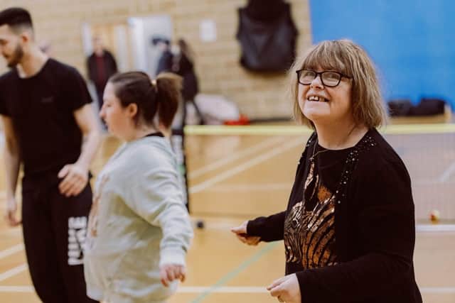 A lady smiling as she enjoys sports