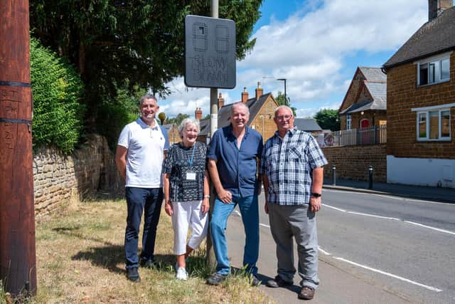 Kislingbury Parish councillors Jamie Dye, Sue Deane, Chris Payne and Malcolm Spalding next to the speed reduction sign Danielle’s office helped to fund.