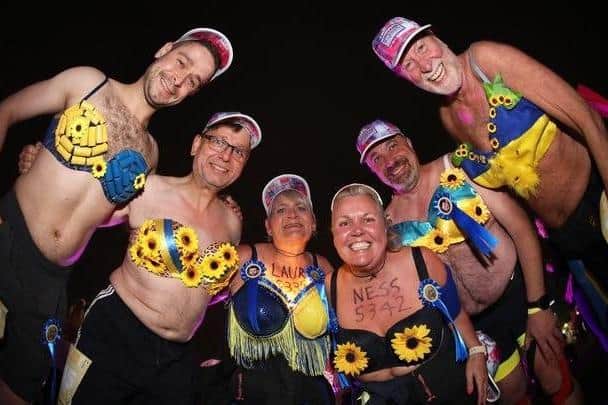 Laura Rothwell and her team wearing blue and yellow bras in support of their heroes in Ukraine including President Zelensky at the Walk the Walk Moonwalk.
Photo by: Paul Brown/epic-fotos.com
