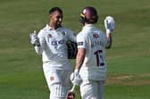 A smiling Saif Zaib celebrates with Lewis McManus after reaching his century (Photo by Shaun Botterill/Getty Images)