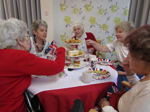 Residents at St. Christopher's Care Home enjoy their Coronation Day Afternoon Tea.