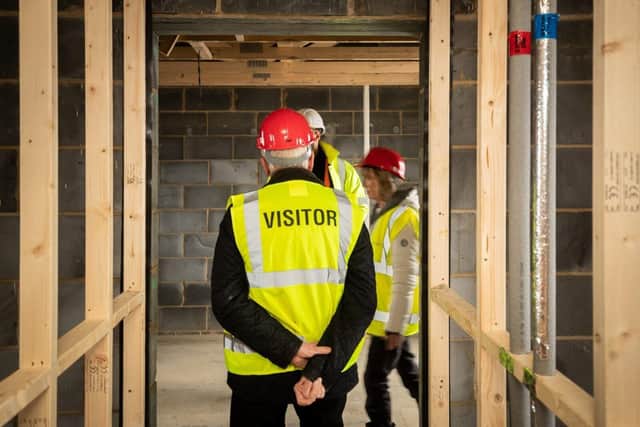 B&DWC - 028 (002) - Visitors walking around a Barratt home at a Hard Hat event