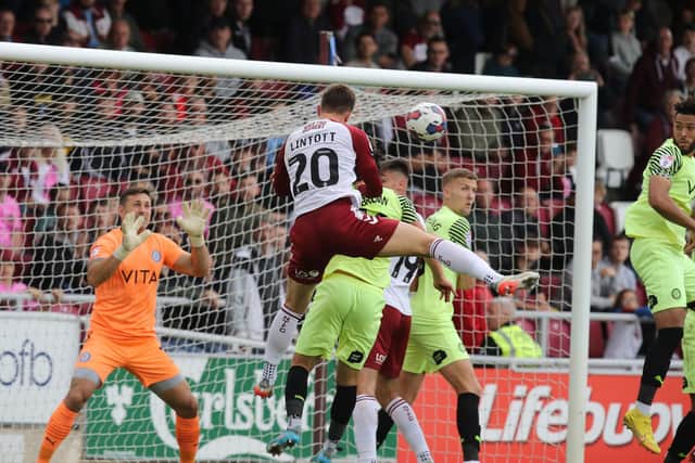 Harvey Lintott heads in his first professional goal. Picture: Pete Norton.