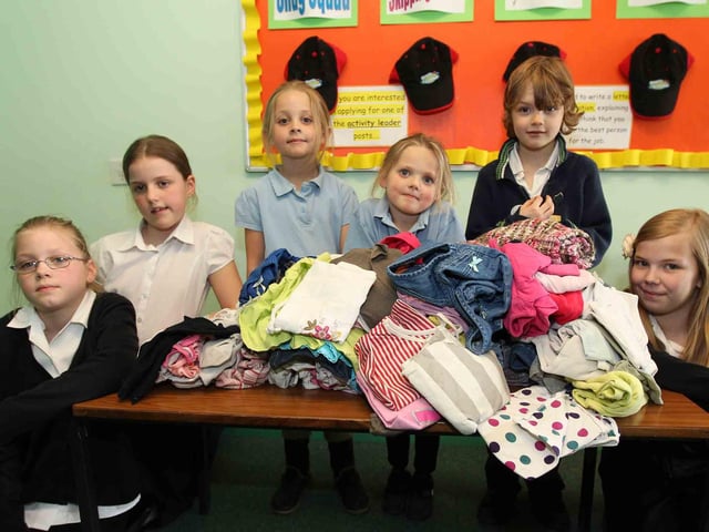 Firefighters from Moulton fire crew visiting children at The Arbours Primary School as part of an emergency services day.  Pictured: Children who donated clothes for the Fire Fighters Charity.