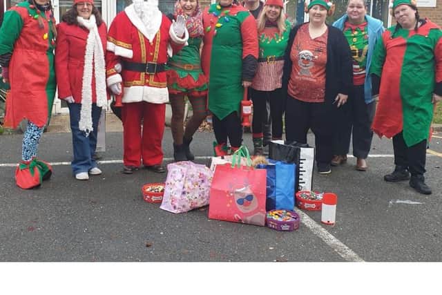 Santa and his elves before their travels in 2023