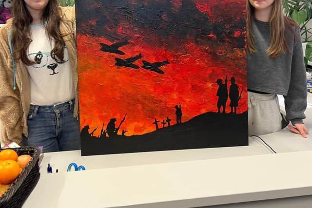 Students posing with Artwork