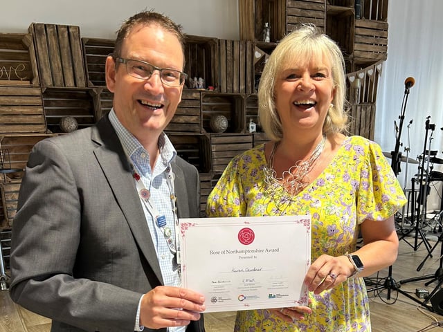 Councillor David Smith from West Northants Council presenting Karen Gardner, The Good Companions, with a Rose of Northamptonshire Award. Karen Gardner supports The Good Companions in Northampton, providing entertainment, refreshments, friendly chat and support to anyone who needs it.