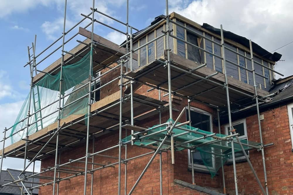 Scaffolding surrounds 102 Ashburnham Road, where a rooftop extension is being built despite planning documents stating no extensions were proposed.