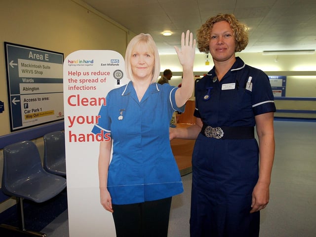 2010 - Helen Belk, assistant modern matron - medicine and emergency care at Northampton General Hospital, next to a cardboard cut-out of a nurse which uses a voice box to remind people to wash their hands