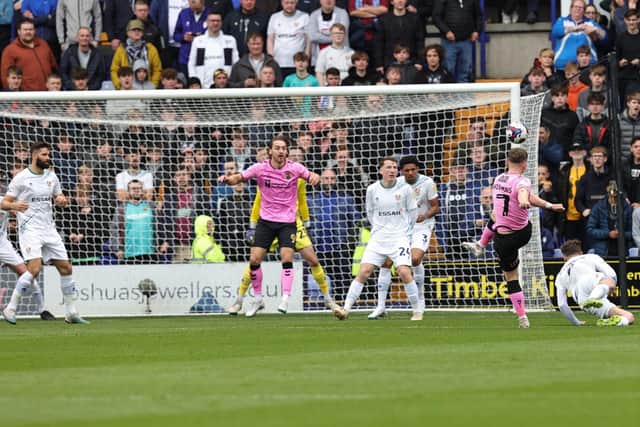 Sam Hoskins volleys in the opening goal against Tranmere. Pictures: Pete Norton