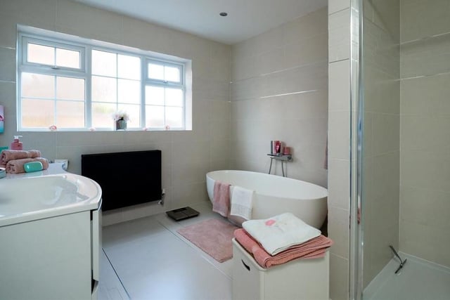 Estate agents Bairstow Eves describe this family bathroom as stunning. Recently fitted, it features a high-specification four-piece suite that includes (to the right) a double shower enclosure..