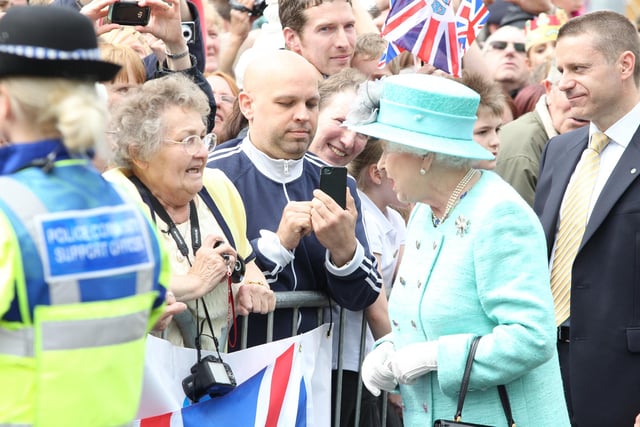 Her Majesty Elizabeth Queen II chats to a well-wisher in the crowd