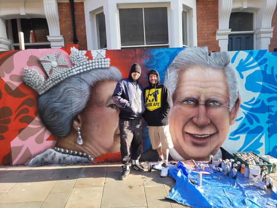 The artists proudly showing off their new royal mural.
