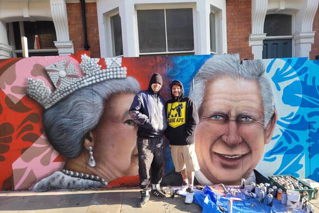 The artists proudly showing off their new royal mural.