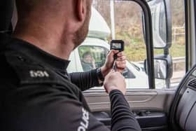 Police officers use an unmarked HGV to get an elevated position where they can see if drivers are committing offences.