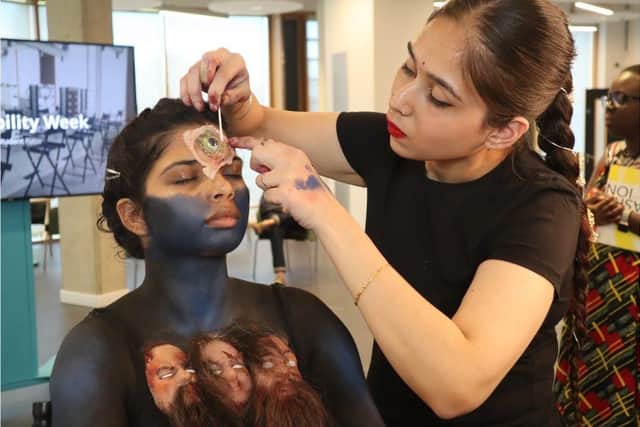 Student Ojas Kaur applies prosthetics live to a model at UON'S Degree Show 2024.